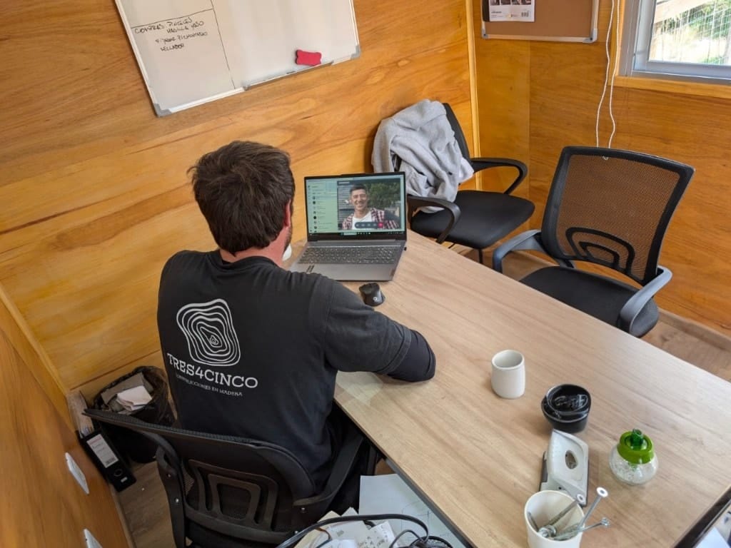 Ramiro in the site office at his laptop, on a WhatsApp video call.