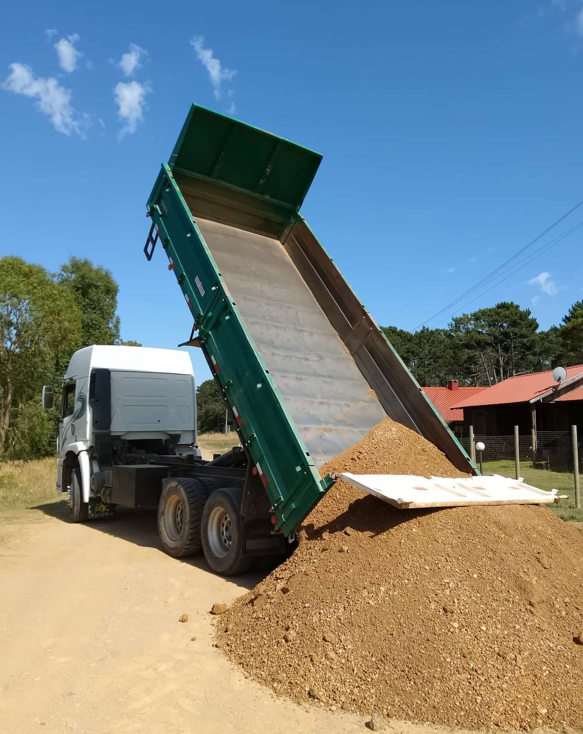 A tipper truck unloads earth for the plot of Casa Azul.