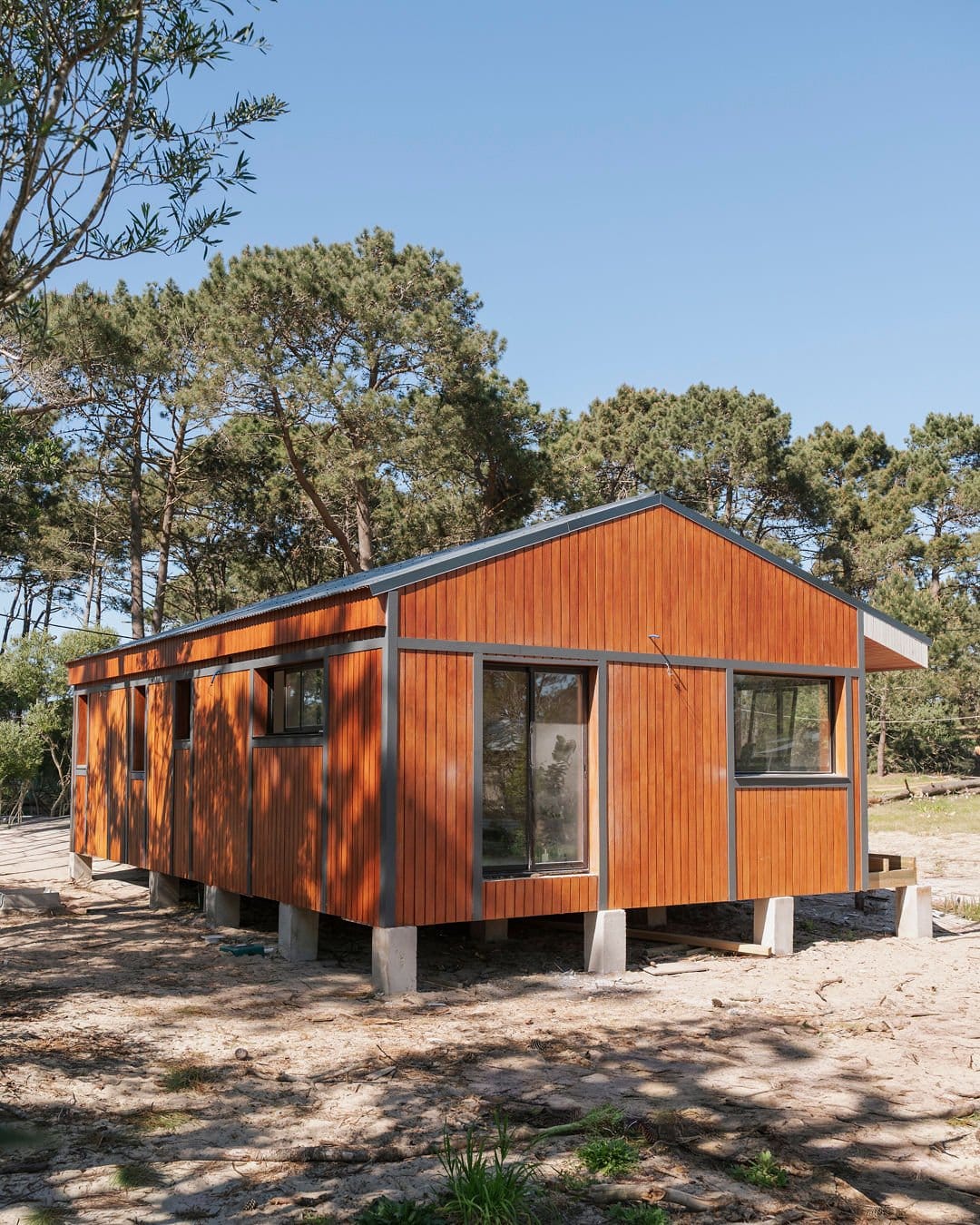 House clad in timber on concrete piers